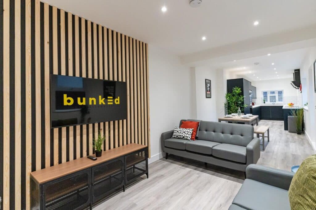 A Bunked communal living area with a flatscreen TV